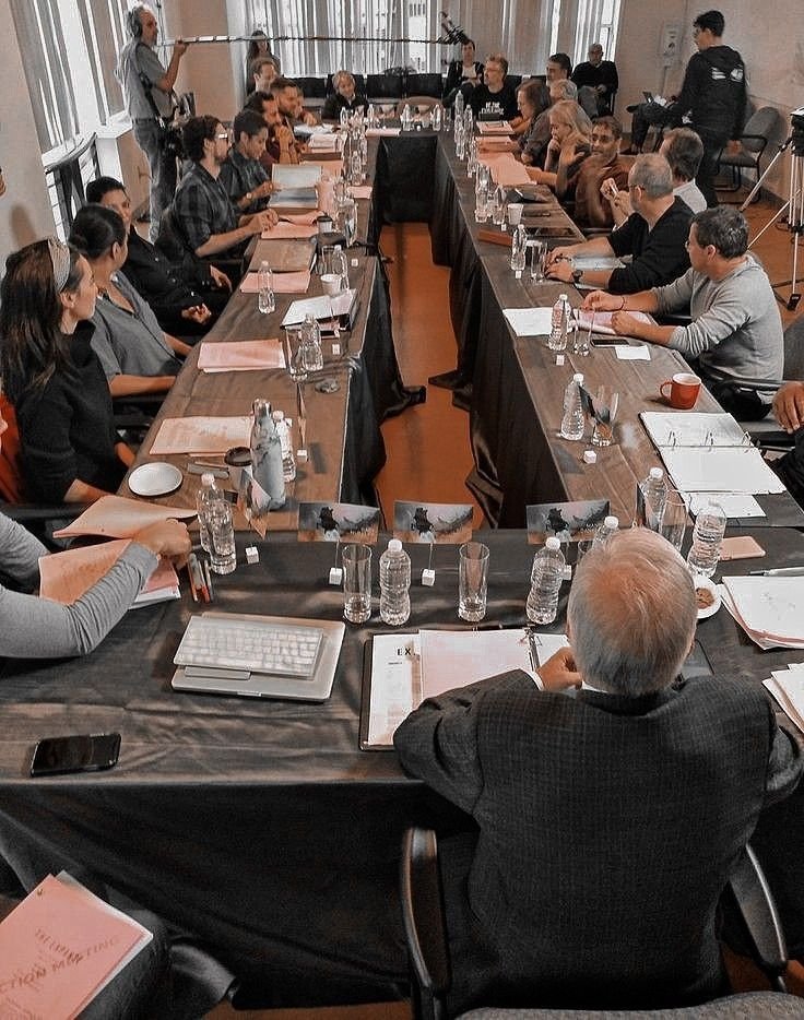 Authors and publishing professionals meeting around a working editorial table